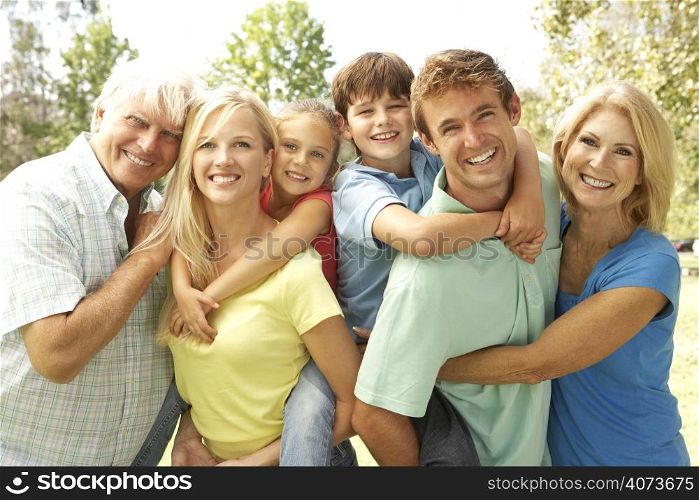 Mother And Father Giving Children Piggy Back With Grandparents