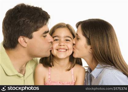 Mother and father kissing smiling daughter on cheek.