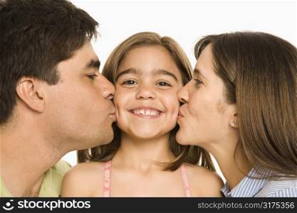 Mother and father kissing smiling daughter on opposite cheeks.