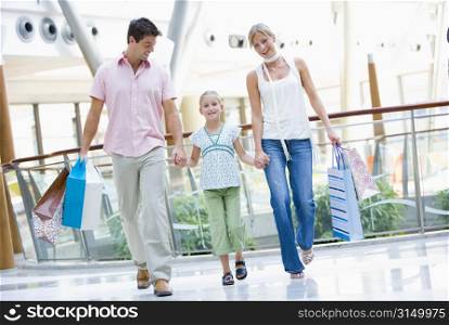 Mother and father with young daughter at a shopping mall