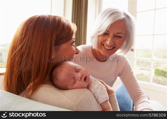 Mother And Grandmother With Sleeping Newborn Baby Daughter