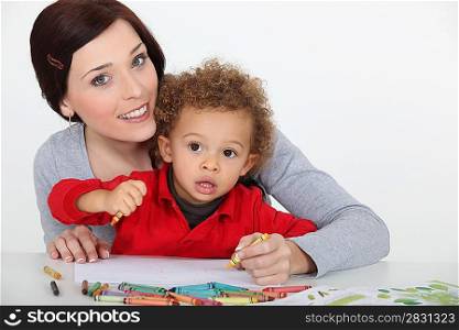mother and her baby boy drawing
