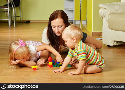 mother and her childs playing with cubes at home