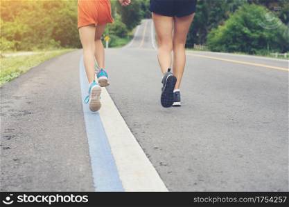 mother and her daughter running on the road in the countryside, sports, healthy lifestyle
