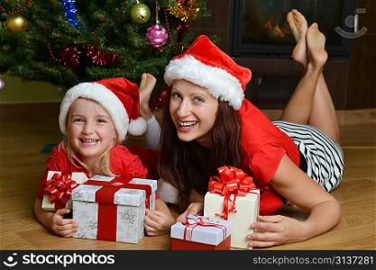 mother and her daughter with cristmas presents