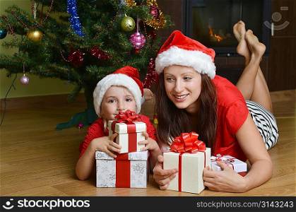 mother and her daughter with cristmas presents