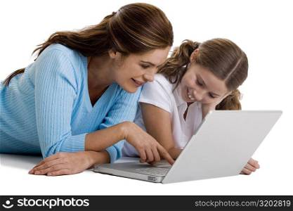 Mother and her daughter working on a laptop