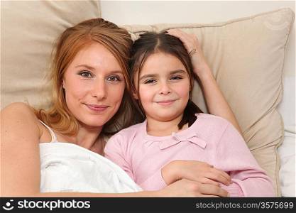 mother and her little girl in bed