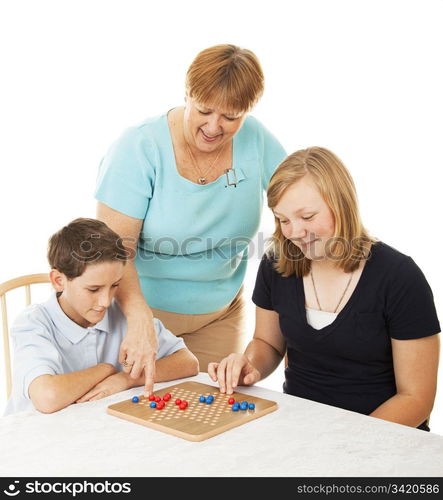 Mother and her two children playing a board game together. White background.