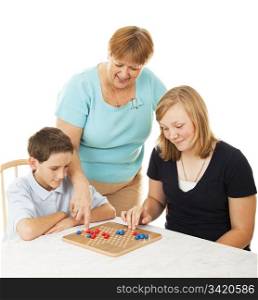Mother and her two children playing a board game together. White background.