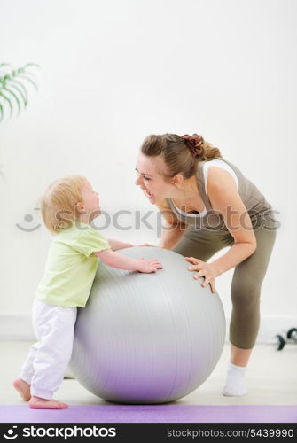 Mother and kid having fun in gym