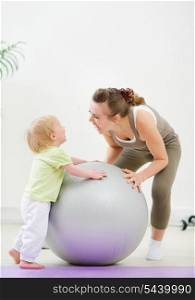 Mother and kid having fun in gym