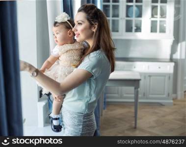 Mother and little baby relaxing in a stylish interior