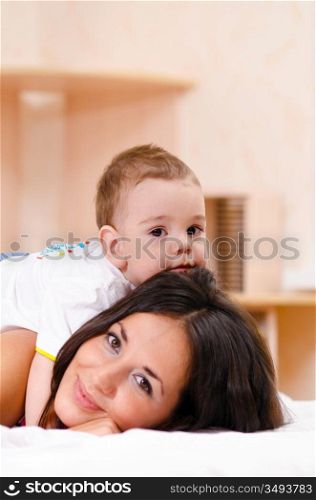 mother and son are playing at home, focus on baby