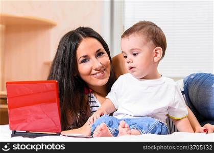 mother and son are using laptop at home