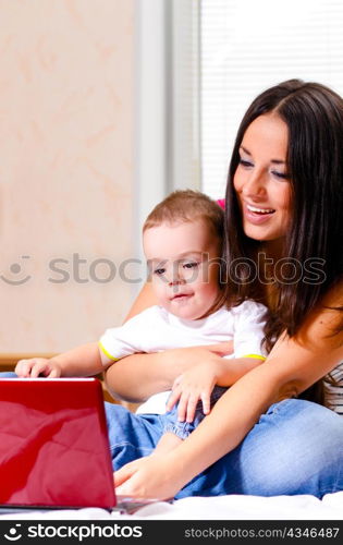 mother and son are using laptop at home