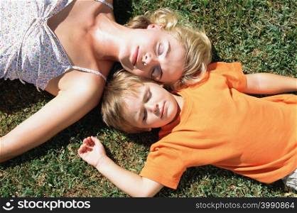 Mother and son asleep on the lawn