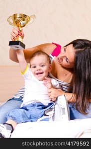 mother and son at home with cup