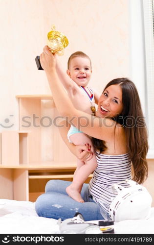mother and son at home with cup