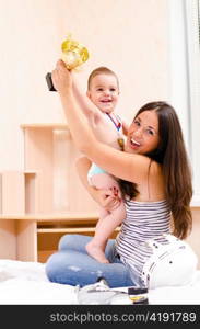 mother and son at home with cup