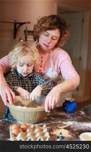 Mother and son baking together in kitchen
