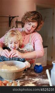 Mother and son baking together in kitchen