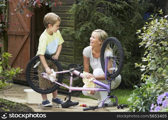 Mother And Son Cleaning Bike Together