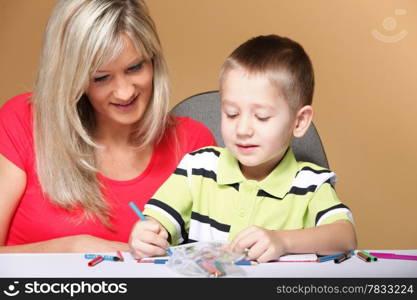 mother and son drawing together, mom helping with homework daycare brown background