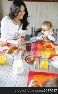 Mother and son eating breakfast at the table