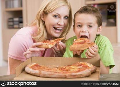 Mother And Son Eating Pizza Together