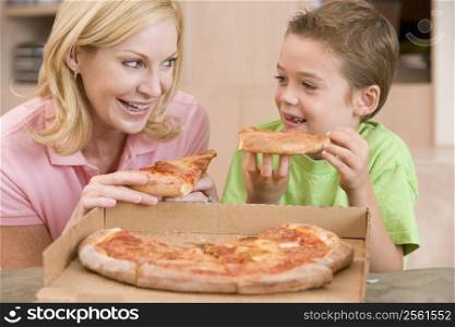 Mother And Son Eating Pizza Together