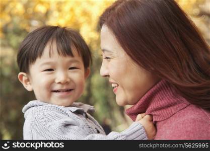 Mother and Son Enjoying a Park in Autumn