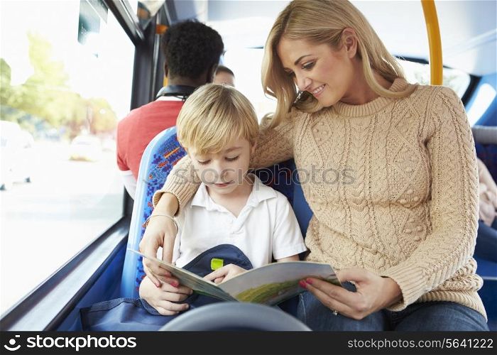 Mother And Son Going To School On Bus Together