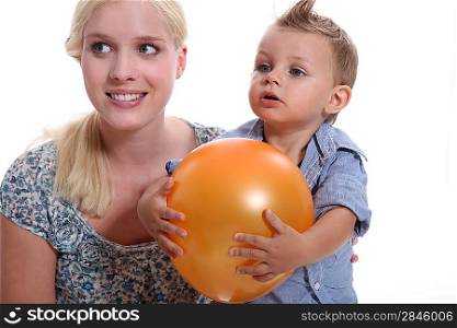 Mother and son holding a balloon.