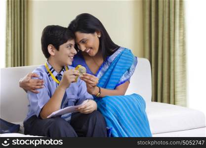 Mother and son holding medal