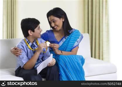 Mother and son holding medal