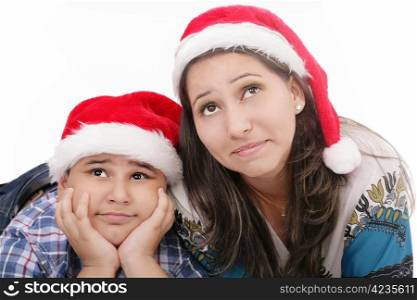 Mother and son in Santa hats smiling and looking up