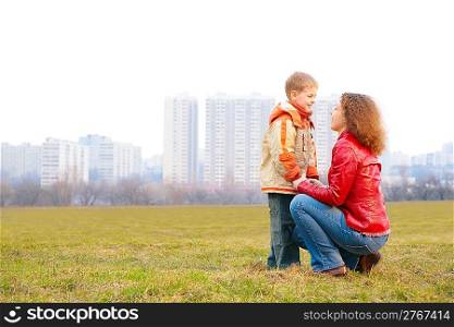mother and son look on each other outdoor