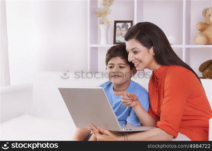 Mother and son looking at laptop