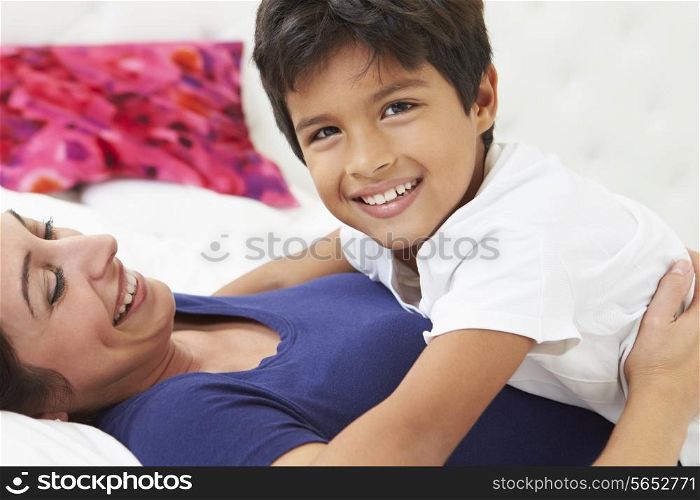 Mother And Son Lying In Bed Together