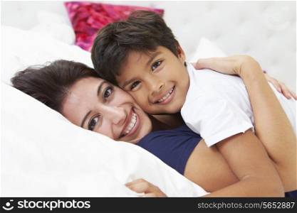 Mother And Son Lying In Bed Together