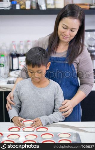 Mother and son making a cake
