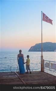 mother and son. mother and son on the pier in the evening at Alania, Turkey