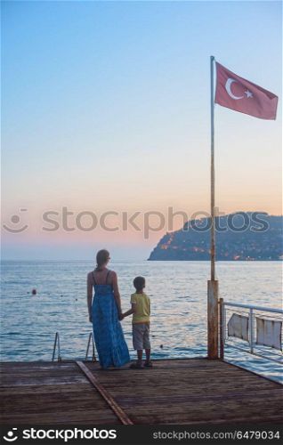 mother and son. mother and son on the pier in the evening at Alania, Turkey