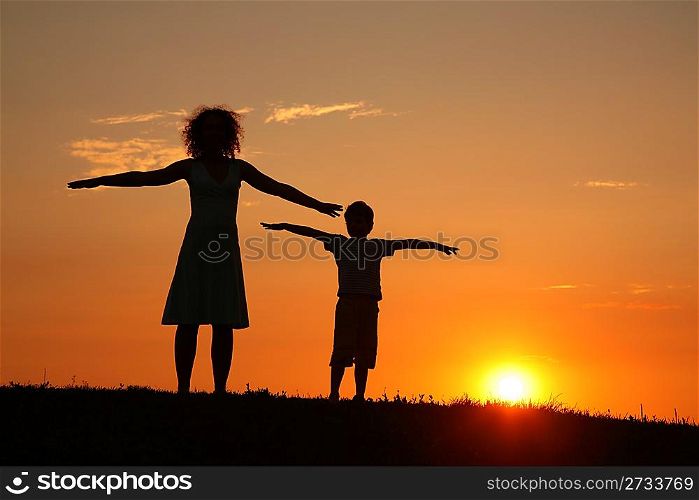 Mother and son on sunset stretching