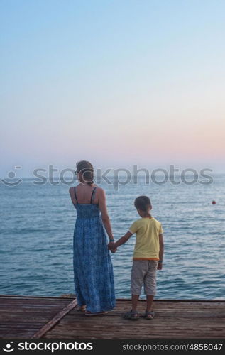 mother and son on the pier in the evening at Alania, Turkey