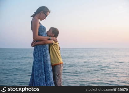 mother and son on the pier in the evening at Alania, Turkey