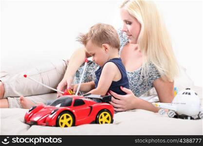 Mother and son playing with an toy car