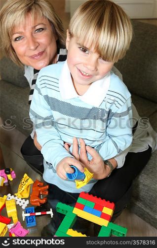Mother and son playing with building blocks