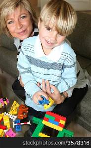 Mother and son playing with building blocks